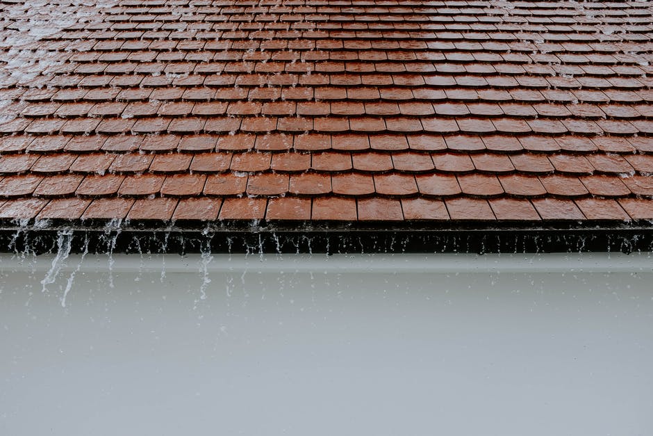 Picture of a roof with water proofing installed by roofing Reno that shows rain water pouring off of it